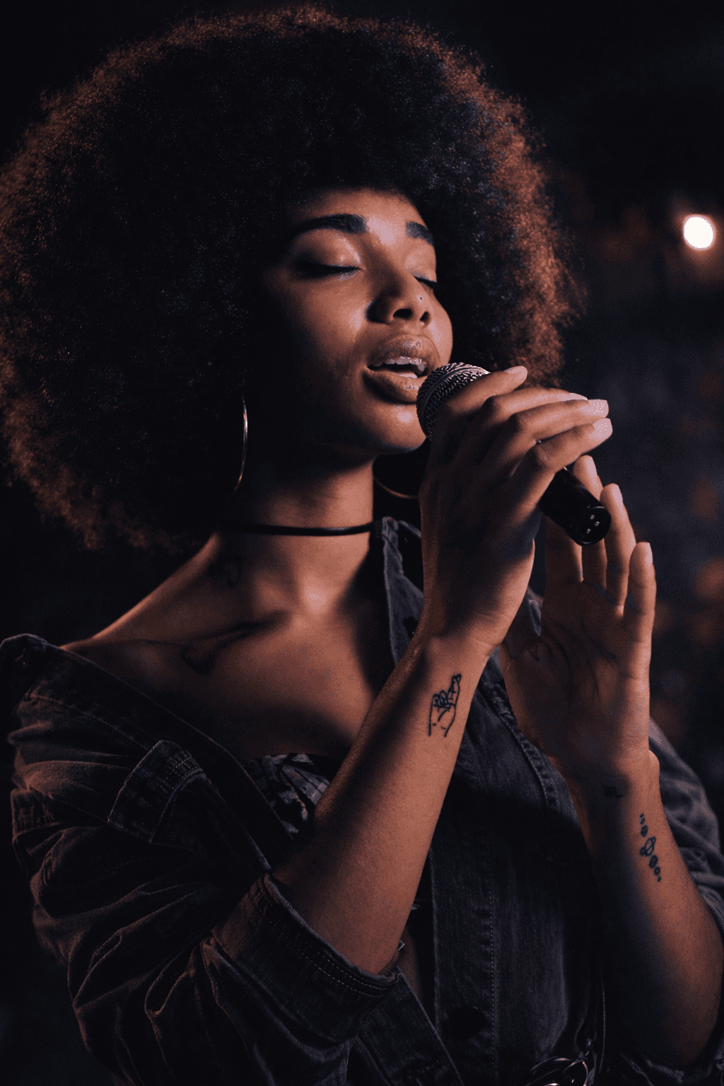 Singer holding a microphone in Loud Behaviour's client showcase.