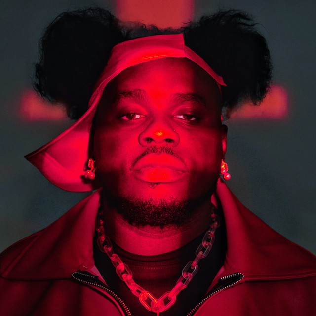 Red-lit artist portrait in Loud Behaviour's client showcase.